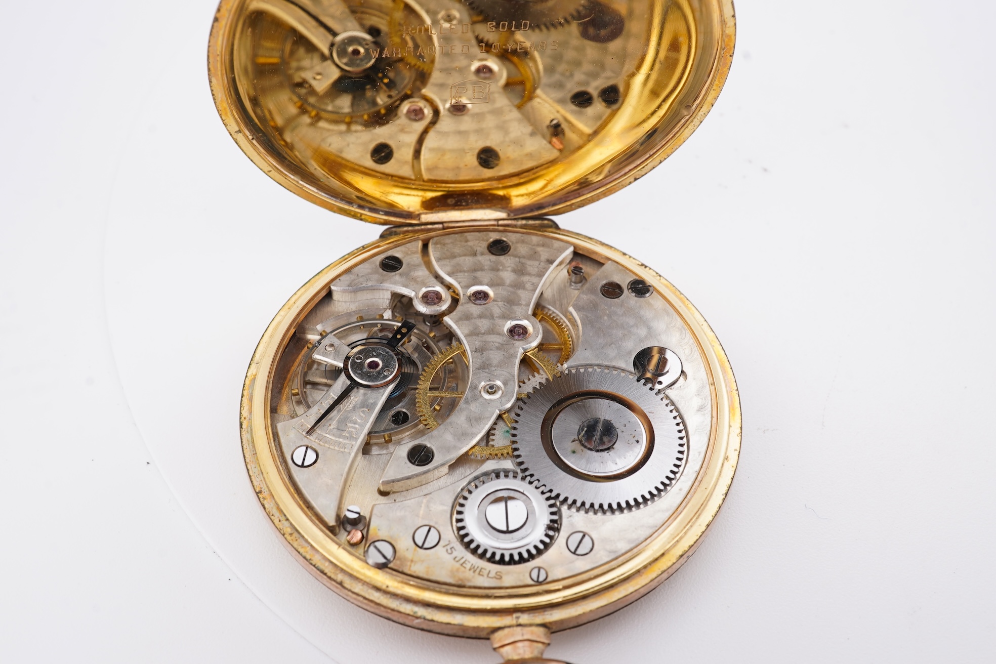 A damaged continental 18k lever pocket watch, together with a rolled gold pocket watch in similar condition.